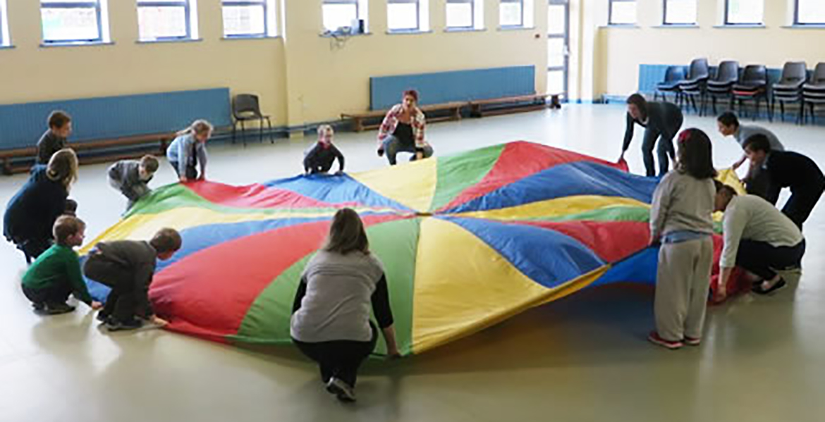 Children with large round flag